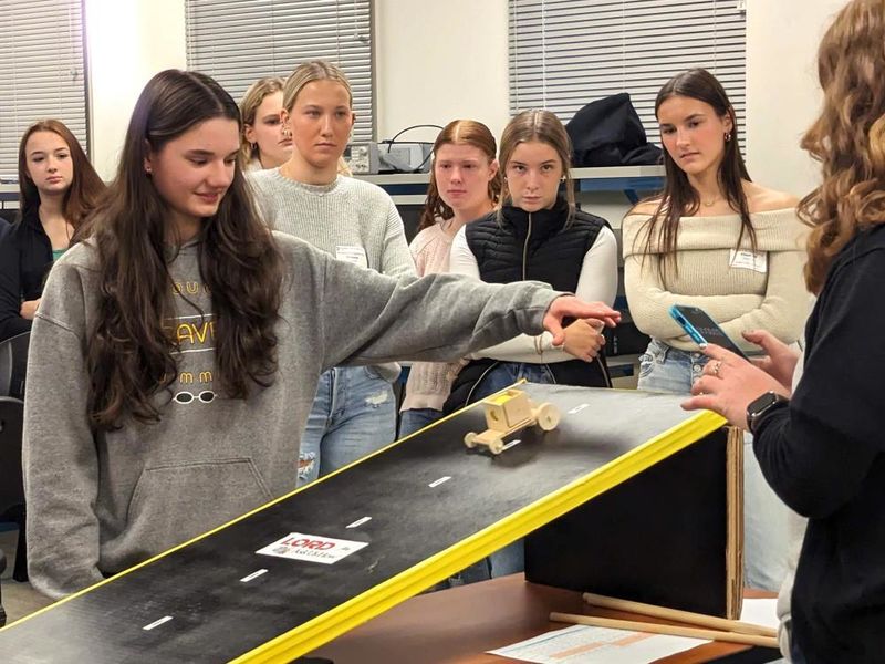High-school girls test a model car during an engineering program at Penn State Behrend.