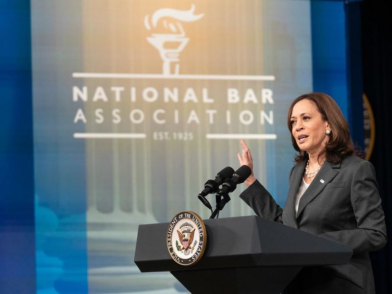 Kamala Harris at a podium with a National Bar Association banner in the background
