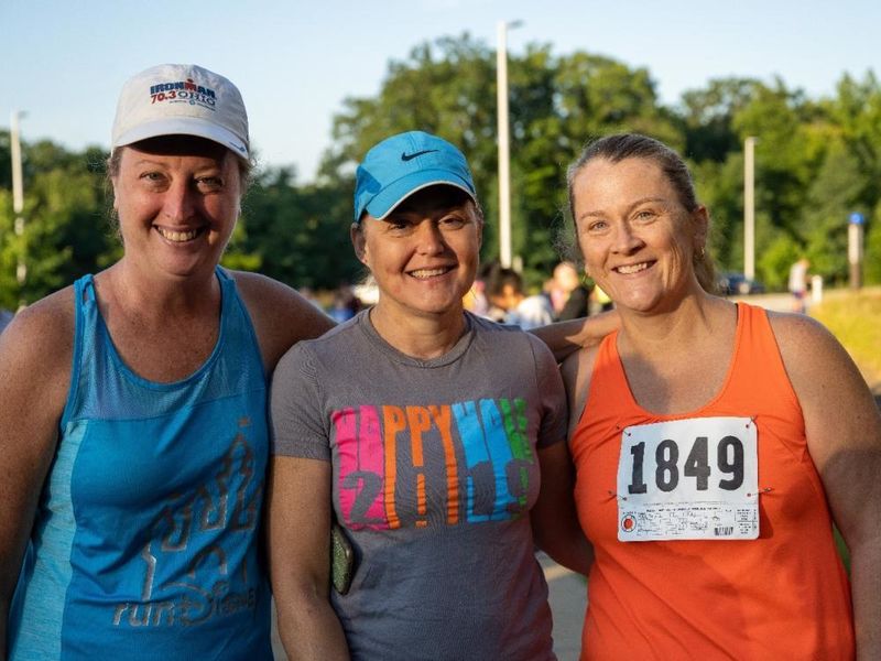 Three women pose at the finish line after the Women's Engagement Council's Run for Women at Penn State Behrend.