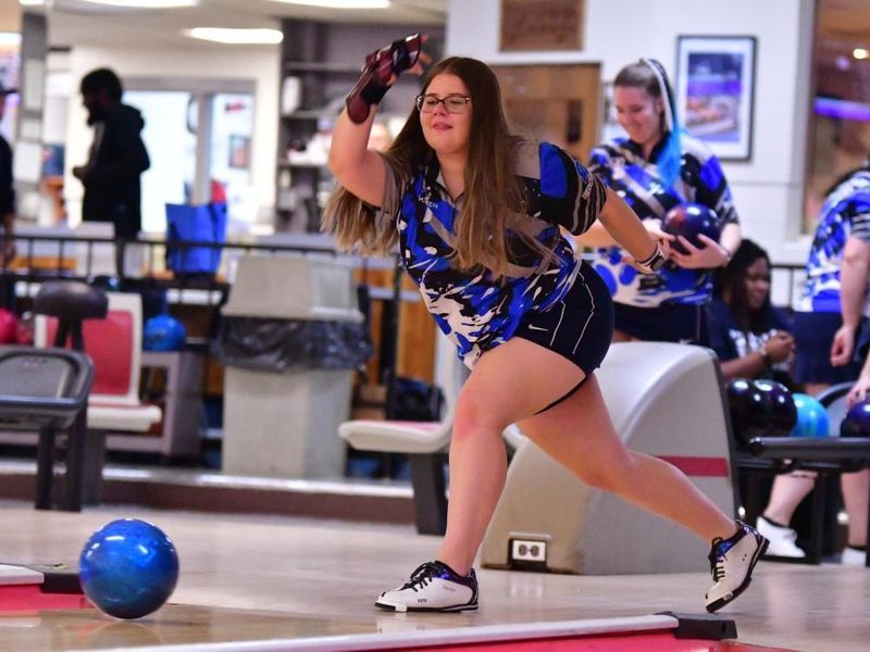 A member of the Penn State Behrend women's bowling team rolls the ball.