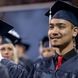 A student smiles during Penn State Behrend's spring 2022 commencement program.