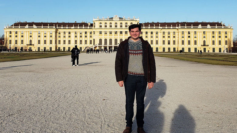 Alumnus Zane Dilts in front of a palace in Vienna