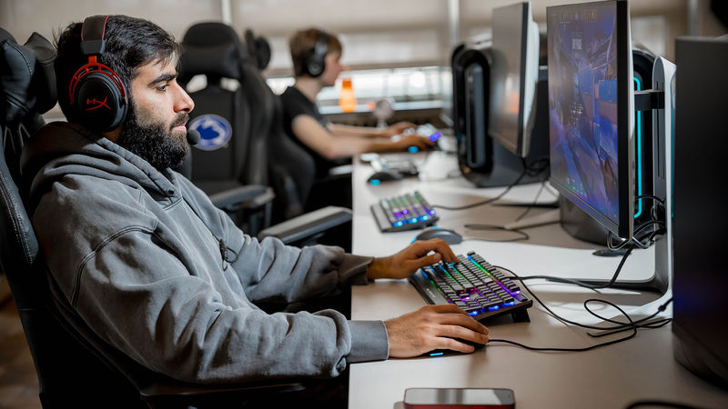 A Penn State Behrend student plays a video game in the college's new esports lounge.