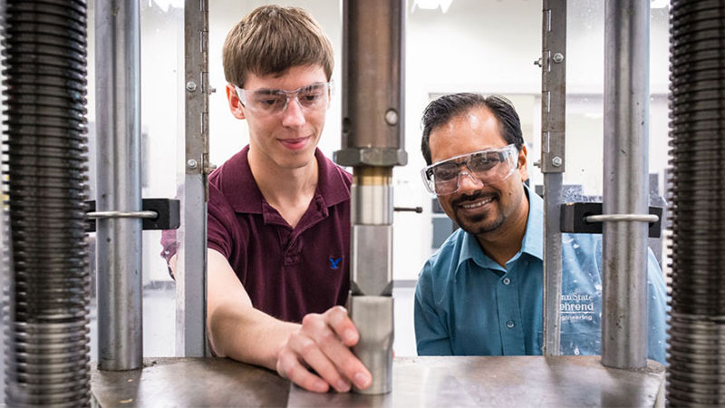 Engineering student and faculty member work on project.