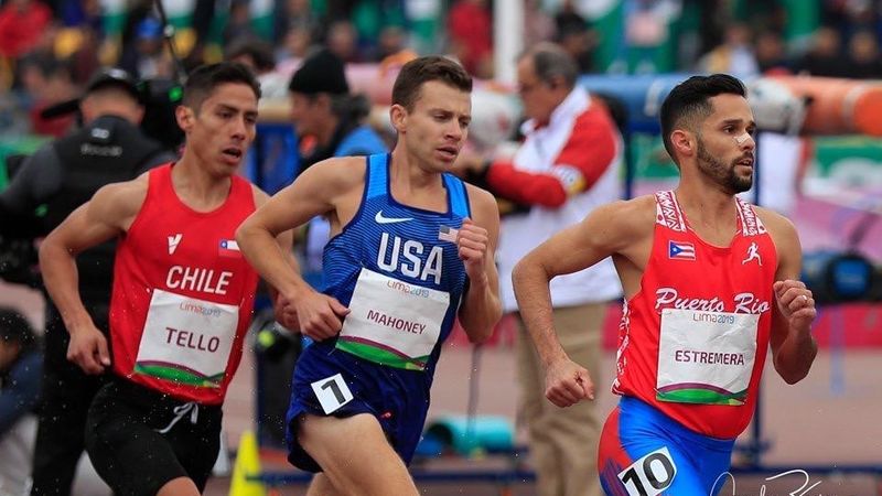 Ricardo Estremera leads a steeplechase race. Three runners compete in a steeplechase race.