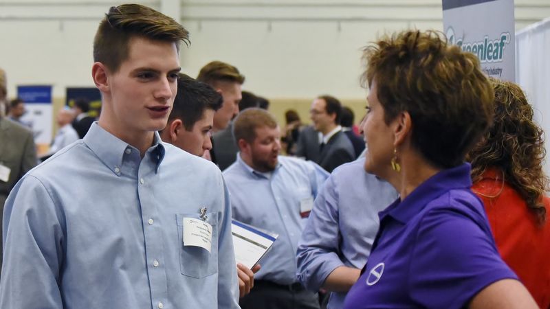 A student talks with a recruiter at the Penn State Berhend fall Career and Internship Fair.