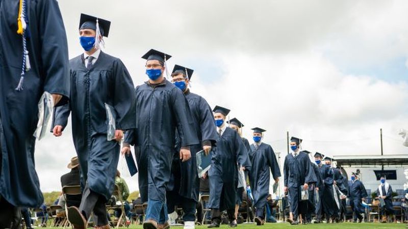 Penn State Behrend graduates leave the college's soccer stadium at the conclusion of the 2021 commencement programs.