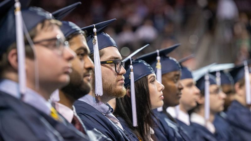 A row of students listen to a speaker during Penn State Behrend's spring 2022 commencement program.