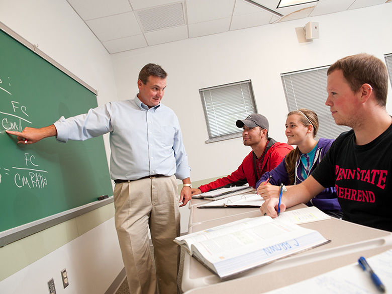 A professor teaches students in a classroom.