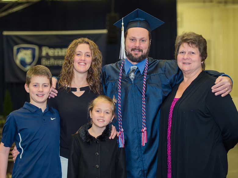 A Penn State Behrend Adult Learner celebrates commencement with his family.