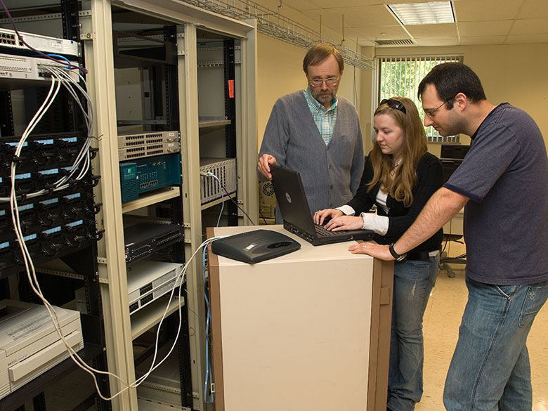 Penn State Behrend I.T. students work with a faculty member to program a rack-mounted server.