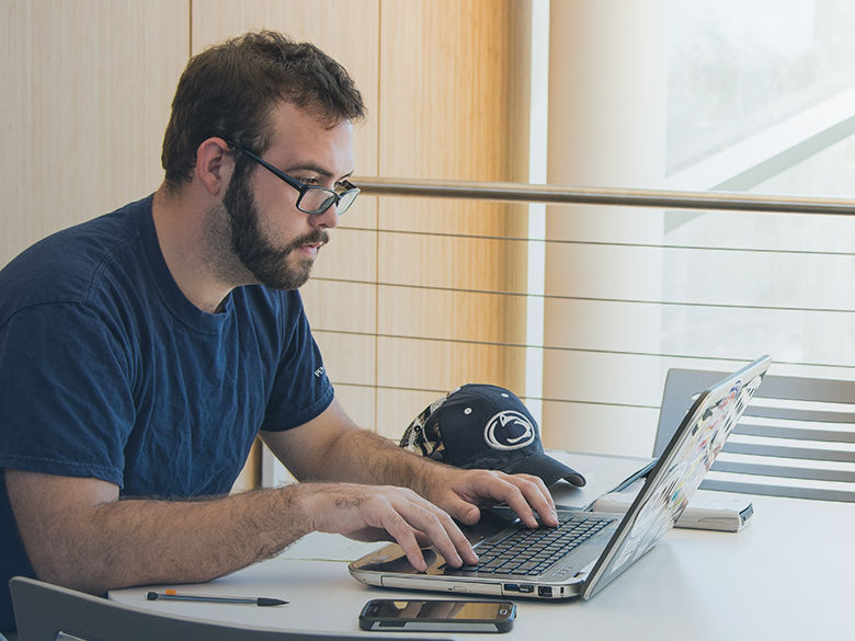 A man studying at a laptop computer