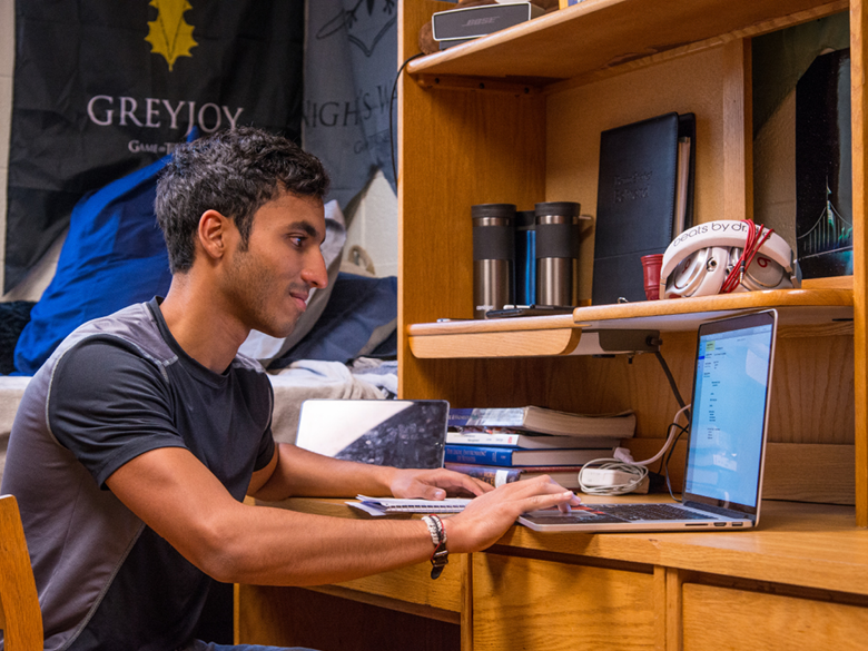 International Student Craig Miranda pictured on his laptop.