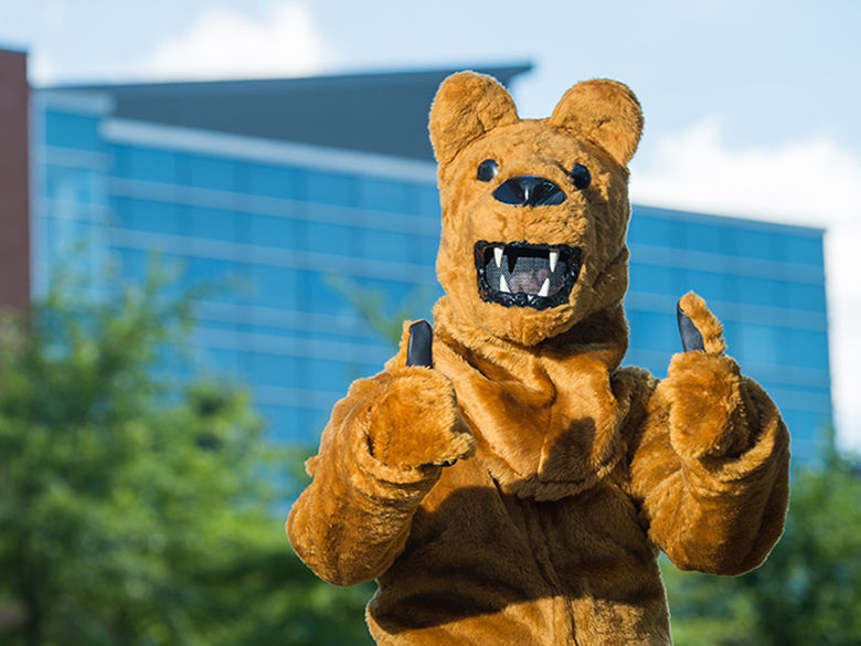 Lion Mascot standing outside Burke Center
