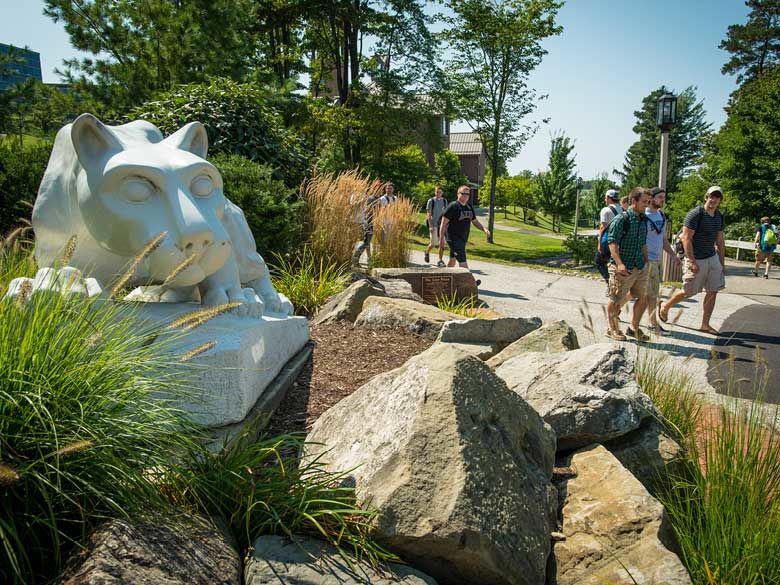 Penn State Behrend students walk by the Lion Shrine.