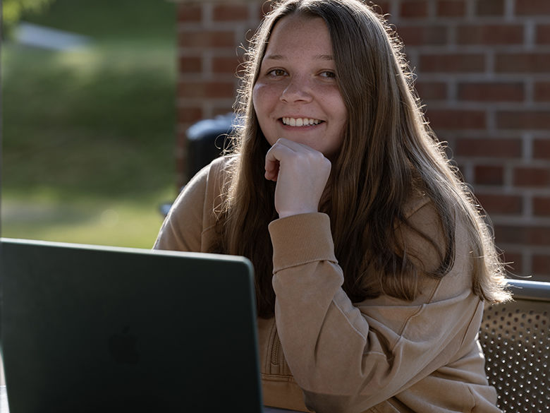 Female student using laptop computer