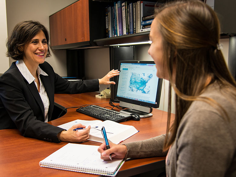 A professor meeting with a Penn State Behrend MBA student