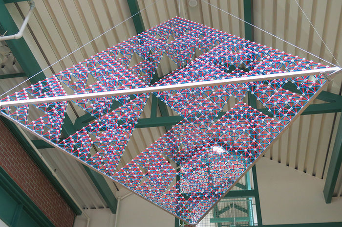 High overhead at the entrance to Roche Hall is a art—a stage-5 Sierpinski tetrahedron that models a fractal with infinite triangles—created by student members of the School of Science Math Club.