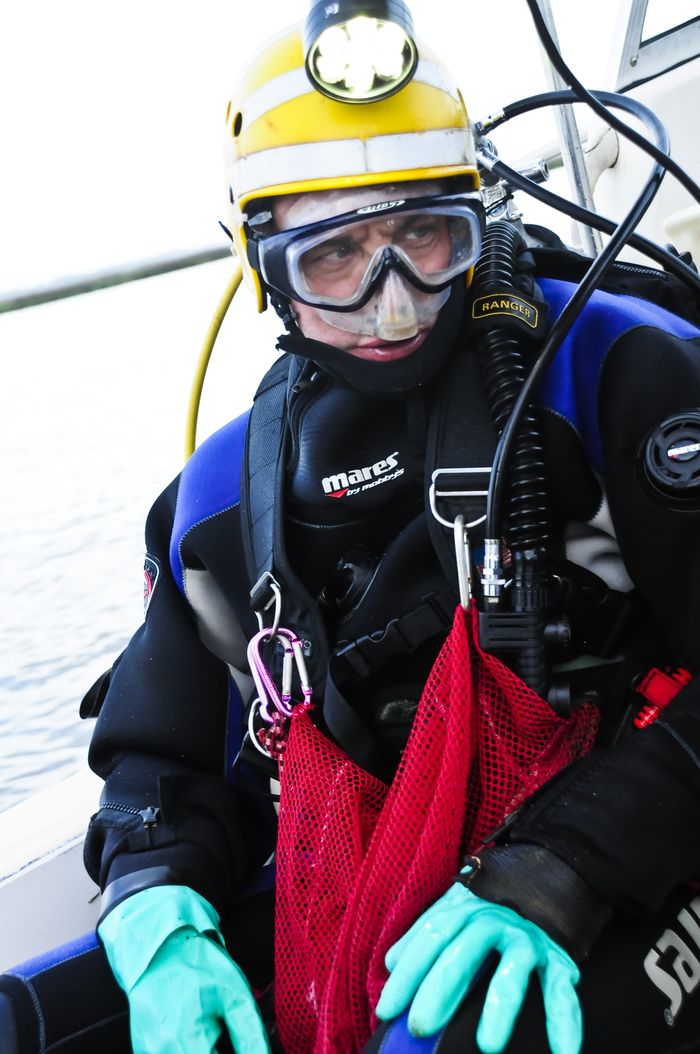 Scuba diver Bill Eberlein prepares to enter the water.