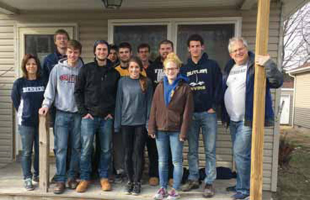 Student-athletes at a Habitat for Humanity build. Students are flanked by athletics staff members Gabi Quiggle, administrative support assistant, and Brian Streeter, senior director of athletics.