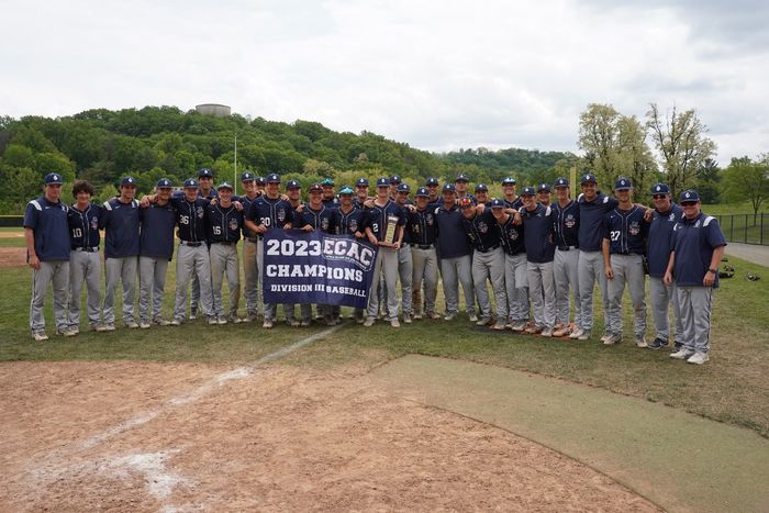 The Penn State Behrend baseball team poses with the ECAC championship banner.