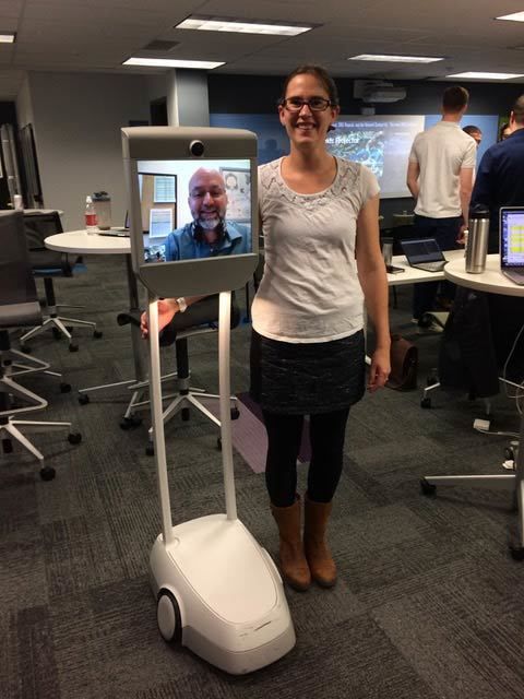 person standing next to beam robot