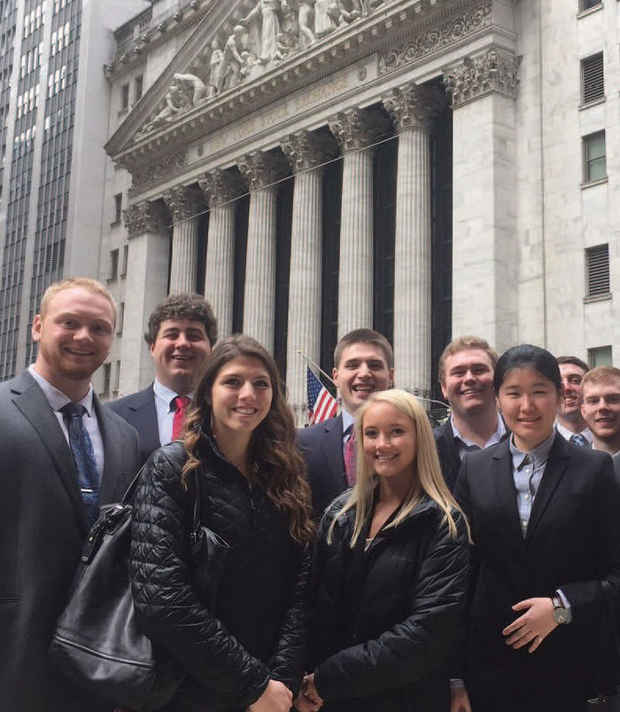 Students in front of the New York Stock Exchange building.