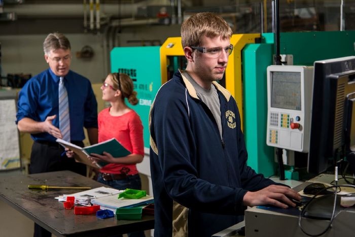 Two students and a faculty member work in Penn State Behrend's plastics engineering technology lab.