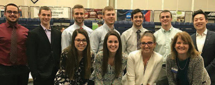Behrend Business Ambassadors pose with the group’s faculty adviser, Linda Hajec, lecturer in accounting, front row, far right, at the GE STEM Fair in Junker Center.