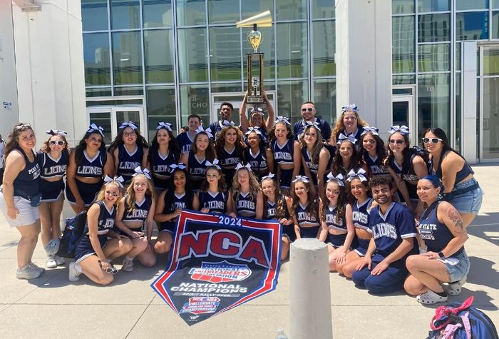 The Penn State Behrend cheer team poses with the trophy after winning the national title.