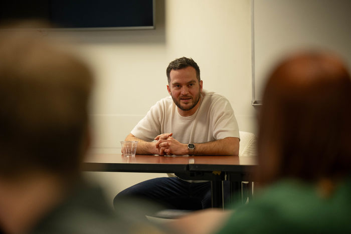 Penn State Behrend alumnus Connor Sattely talks with students in the Reed Union Building.