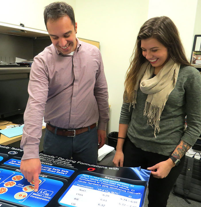 Dr. Sam Nutile, assistant professor of biology, left, and Megan Solan, a senior Biology major, discuss Solan’s award-winning poster.