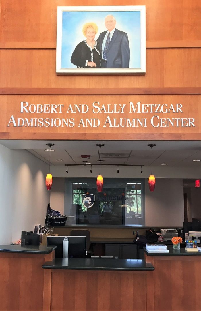 A portrait of Sally and Bob Metzgar, hung above the reception desk at Penn State Behrend's Metzgar Center