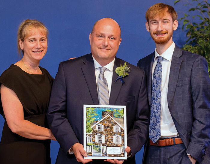 Steven Bugajski, center, at the awards ceremony with his wife, Yvette, and son, Adam, a current Behrend student majoring in Project and Supply Chain Management and Management Information Systems.