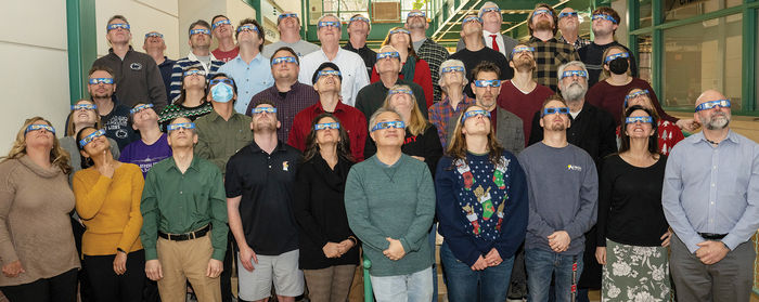 School of Science staff trying out the eclipse glasses.