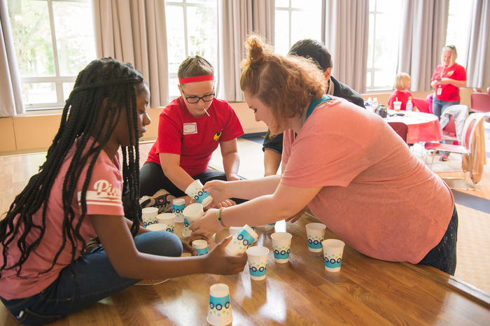 Students play a game with cups.