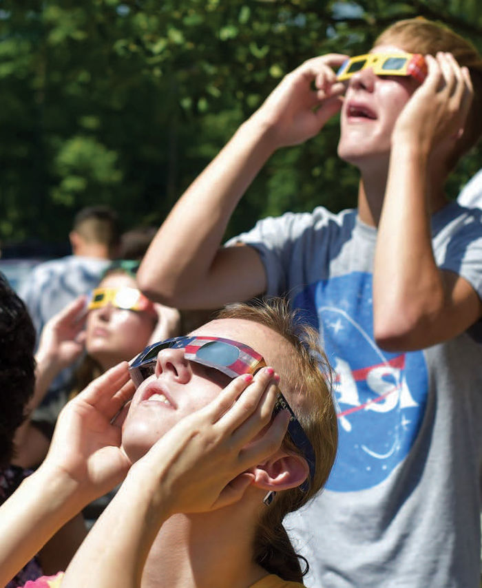 Students of all ages, as well as faculty, staff, and community members, peered through the college’s telescopes, cardboard solar eclipse glasses, and paper-and-tin-foil pinhole viewers to see the moon steal the sun’s spotlight.