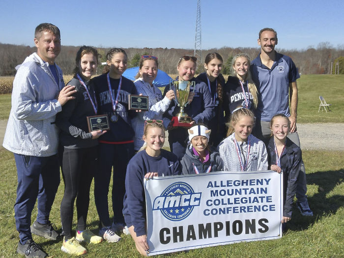 A group photo of the Penn State Behrend women's cross country team with an AMCC championship banner.