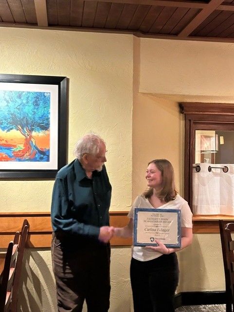 Carlina Edinger accepted the Zachary T. Irwin Humanitarian Award in 2025 from Dr. Irwin