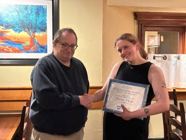 The first winner was Rachel Pineo seen here being congratulated by Dr. Bob Roecklein, who teaches political theory.
