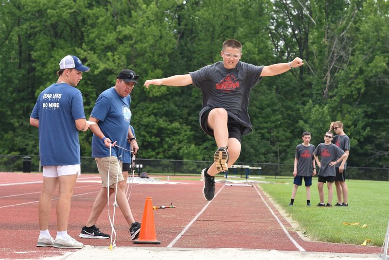 A vision-impaired athlete competes in the long jump.
