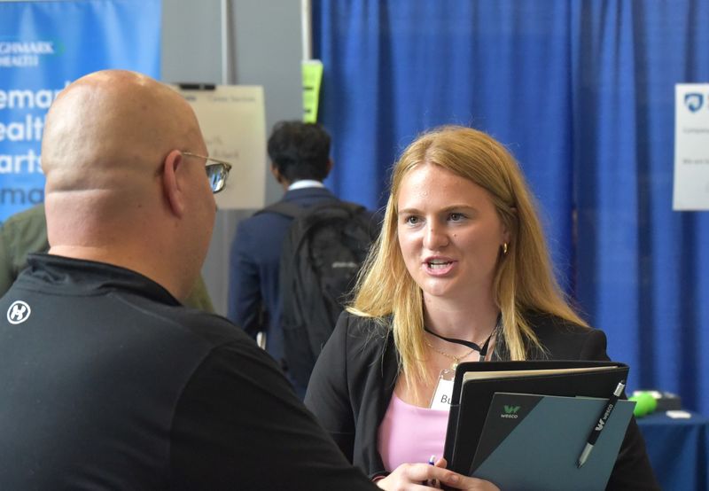 A student talks with a recruiter at Penn State Behrend's fall Career and Internship Fair.