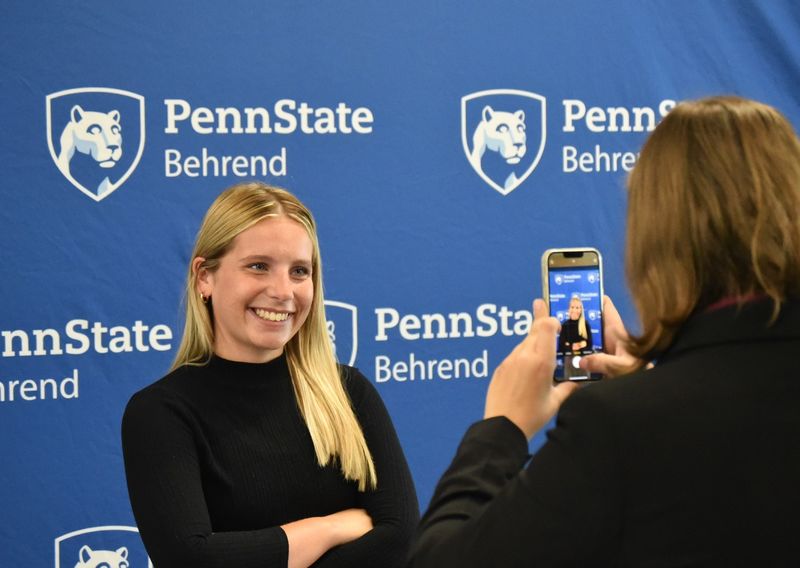 A student poses for a LinkedIn headshot at the Penn State Behrend Career and Internship Fair.