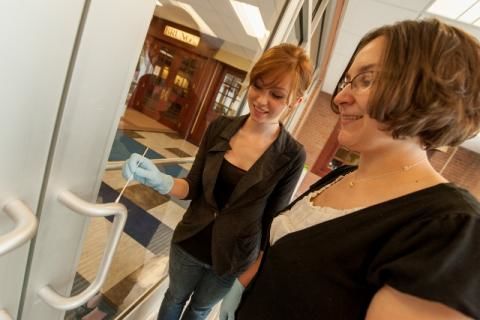 Researchers test for bacteria on a door handle in the Reed Union Building.