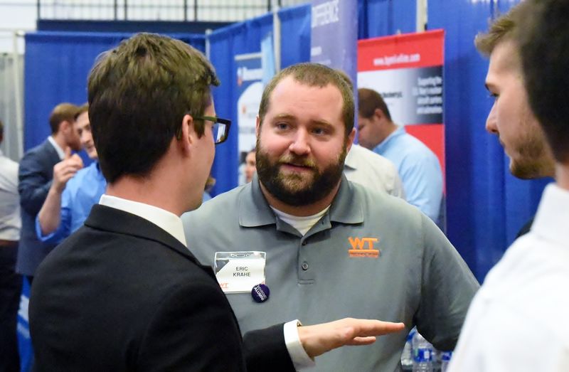 A recruiter talks with students at the Penn State Behrend fall Career and Internship Fair.