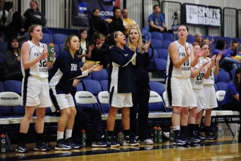 Players cheer during a Penn State Behrend women's basketball game.