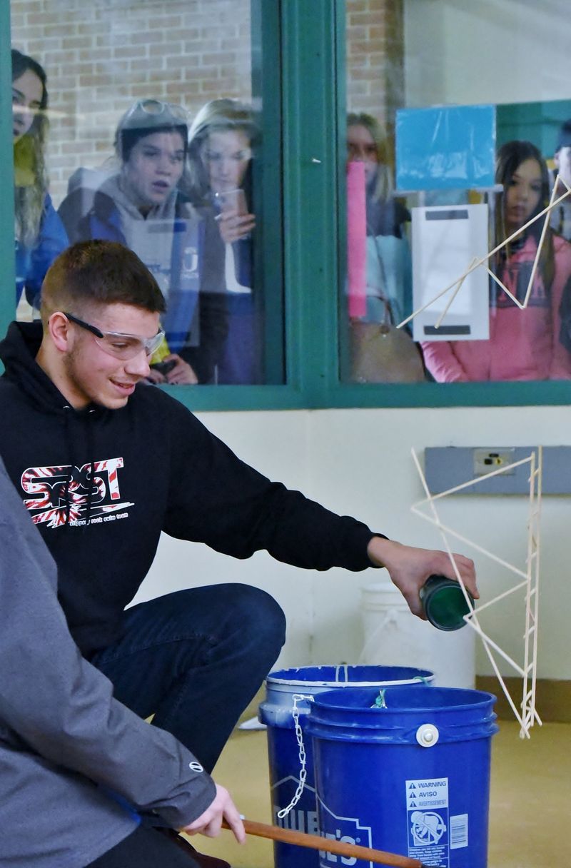 A student reacts as his balsa-wood bridge breaks during a Science Olympiad competition