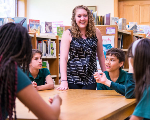 Penn State Behrend student works with school children.