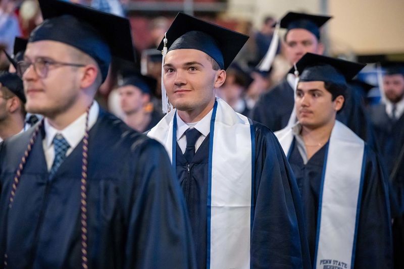 Graduates process into Erie Insurance Arena at the beginning of Penn State Behrend's spring 2023 commencement ceremony.