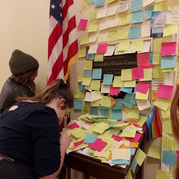 Students leave messages for Representative Alexandria Ocasio-Cortez at the Cannon House Office Building